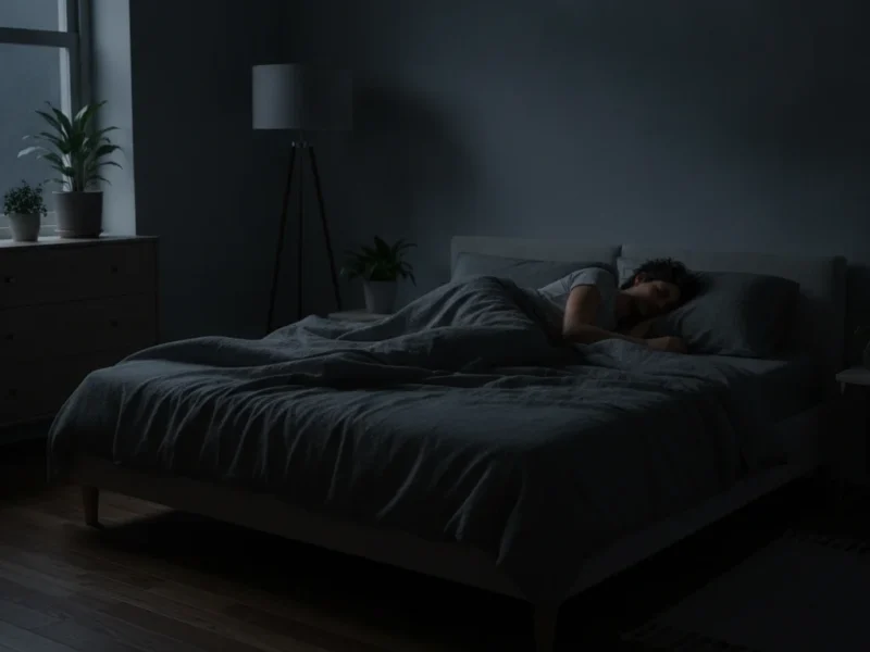 Couple sleeping peacefully in a dark bedroom, with one partner lying on their side to support easier breathing and reduce snoring.